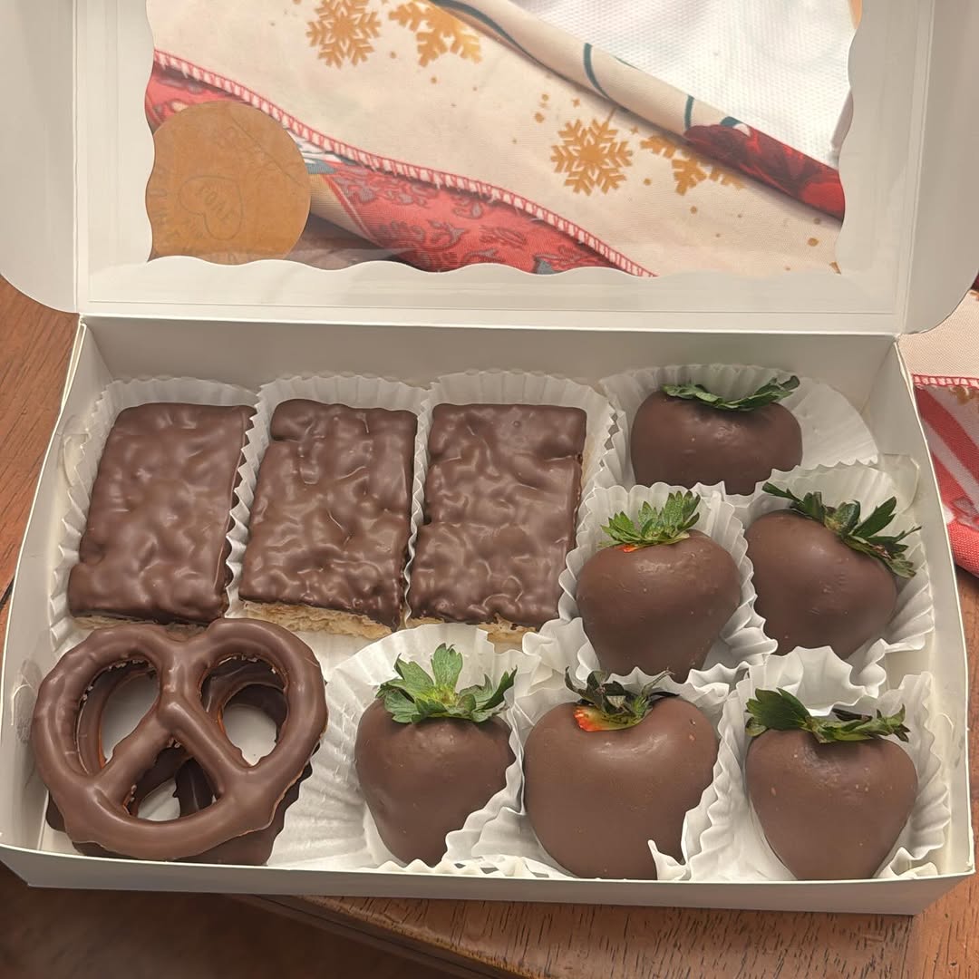 Holiday treat box with four Rice Krispie bars, six strawberries, and a pretzel, all in classic smooth milk chocolate.